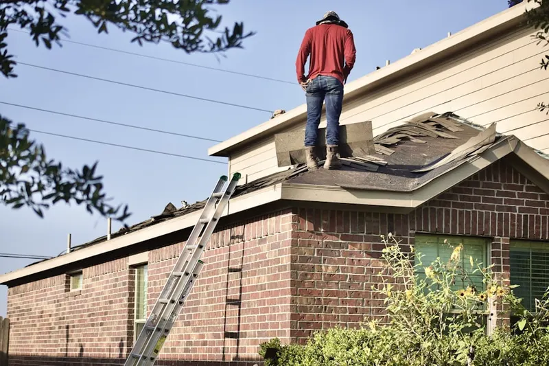 Professional roofer working on a residential roof in Roxboro